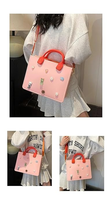 Pink handbag with red handles held by a person wearing a light gray dress.