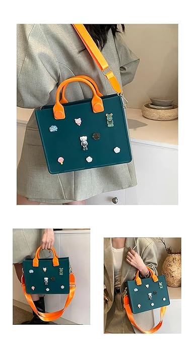 Teal handbag with orange handles and decorative elements worn by a person indoors.