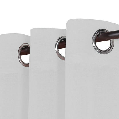 White linen curtains elegantly displayed on a wooden table.