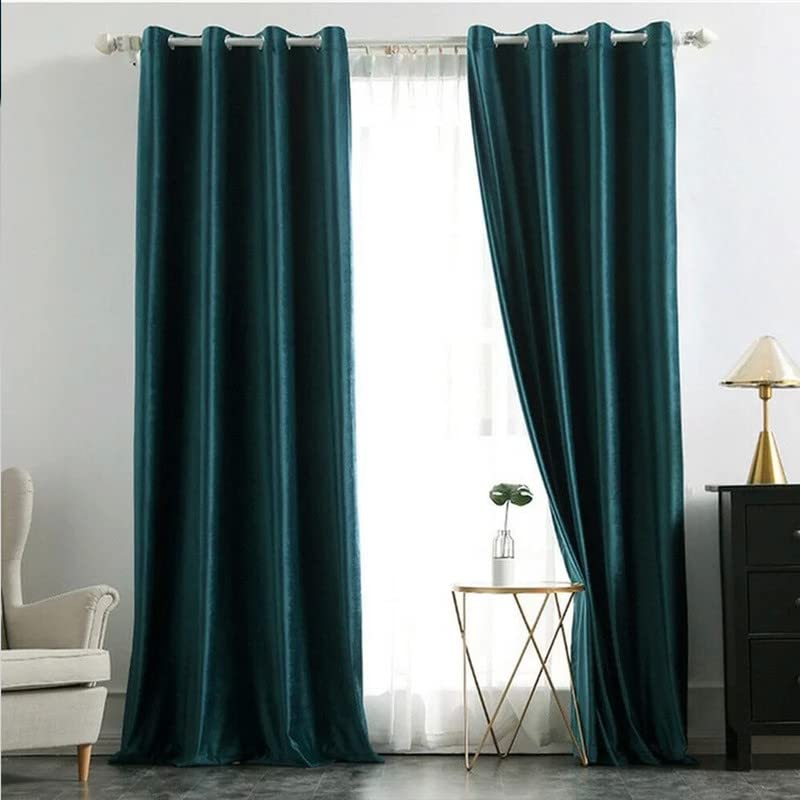  A white vase standing by a dark green curtain.