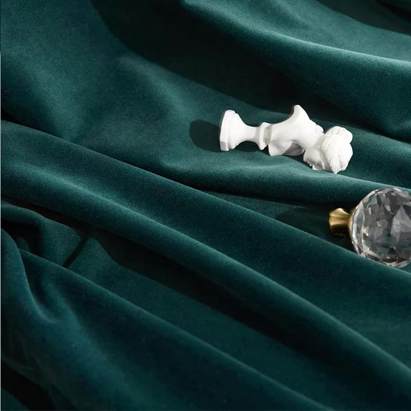 A white vase placed near a dark green curtain.