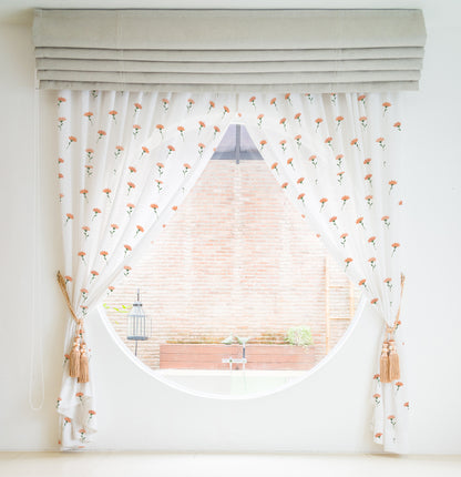 Add a pop of color to your space with this white curtain embellished with orange flowers.