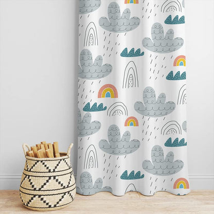 White curtain decorated with colorful rainbows and fluffy clouds.