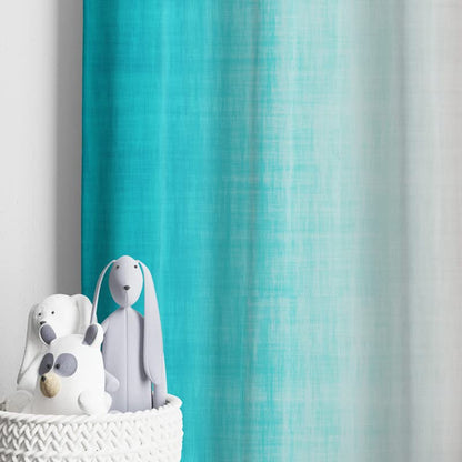  Colorful curtain in pink and blue against a white wall.