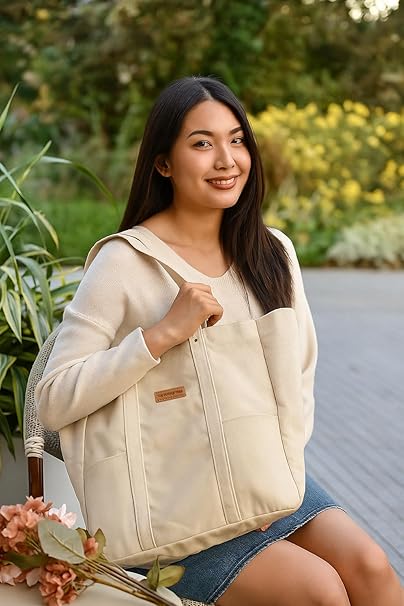 Woman wearing a beige jacket with a floral arrangement in an outdoor setting