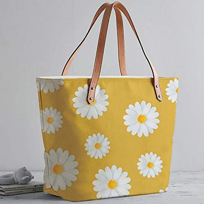 Bright yellow tote bag featuring delicate white daisies, a fashionable accessory for any outfit.