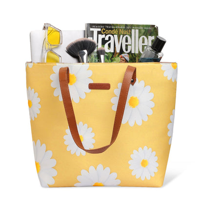 Stylish yellow tote bag adorned with white daisies, ideal for a casual and chic look.