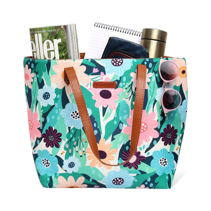 Trendy tote bag featuring a floral design and leather handle.
