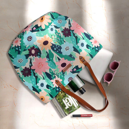 Cute tote bag adorned with floral pattern and leather handle.