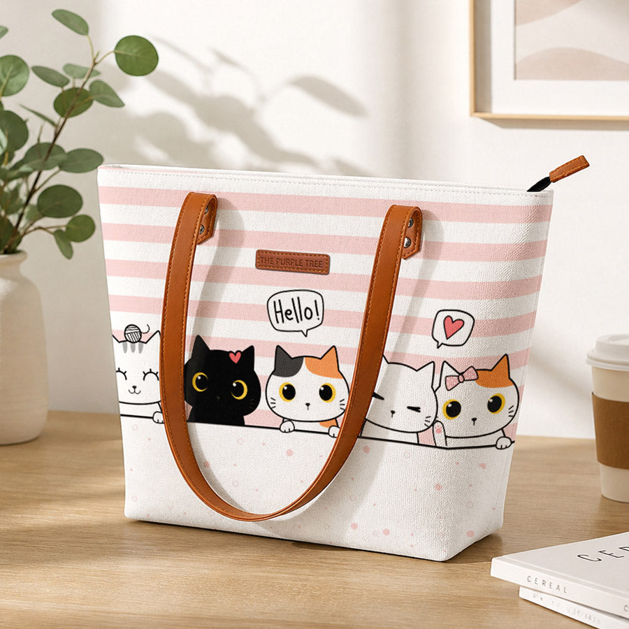 Tote bag with cartoon cats design on a wooden surface