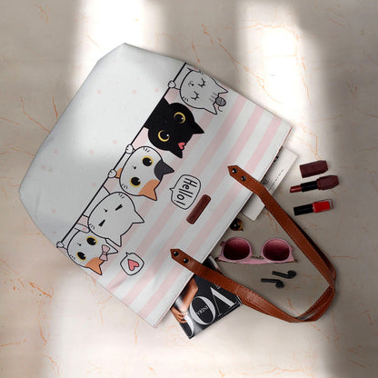 Fashionable tote bag with a whimsical cat design, a fun and functional accessory.