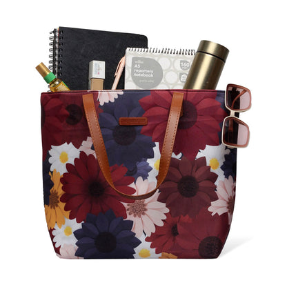  A stylish tote bag with a large floral print design, perfect for carrying essentials on a sunny day out.