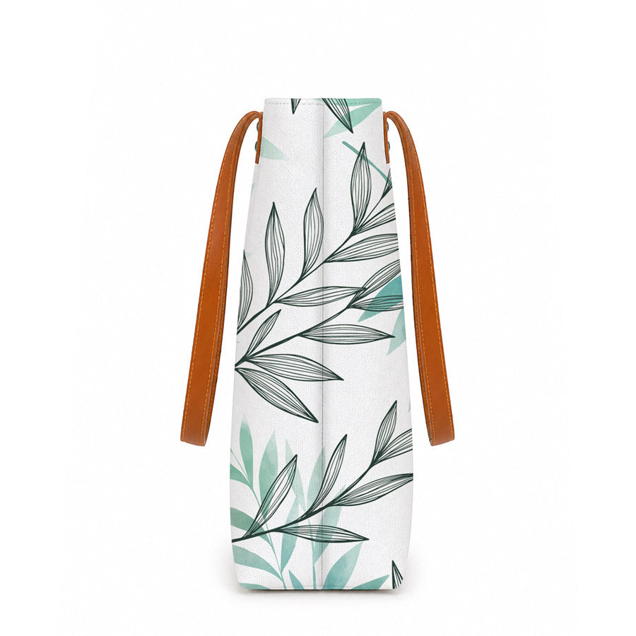 White bag with leaf pattern and brown strap on a white background
