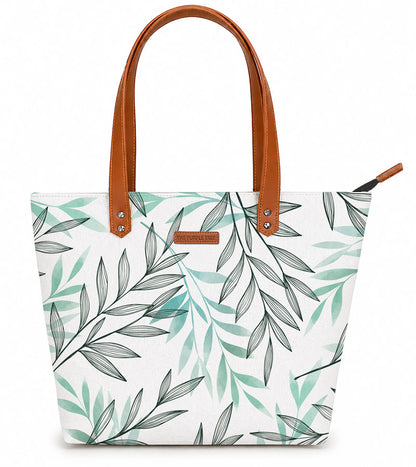 Tote bag with leaf pattern and brown handles on a white background
