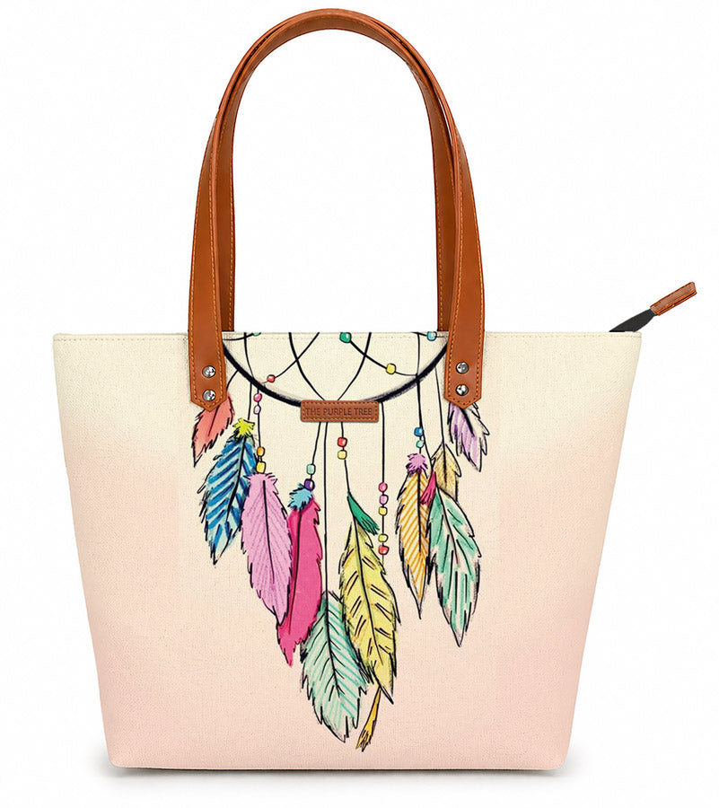 Tote bag with colorful feather design and brown handles on a white background