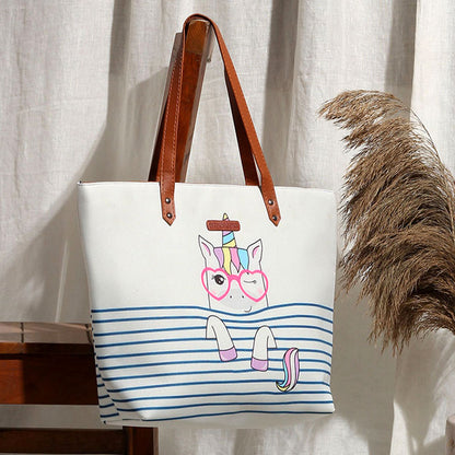 White tote bag featuring a stylish unicorn with glasses, perfect for adding a touch of whimsy to your outfit.