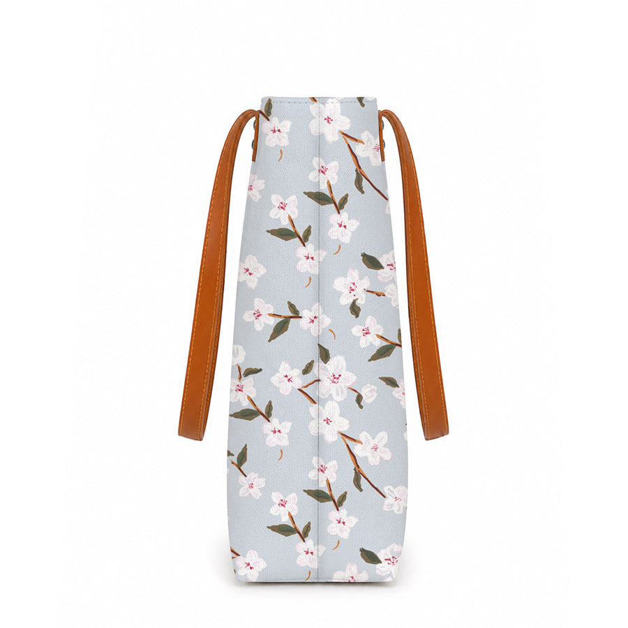 A stylish tote bag with leather handles, featuring a beautiful floral print design. Perfect for any occasion!