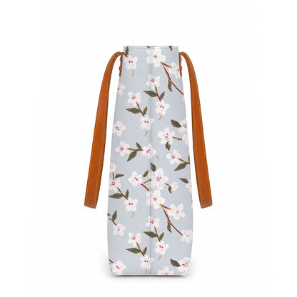 A stylish tote bag with leather handles, featuring a beautiful floral print design. Perfect for any occasion!