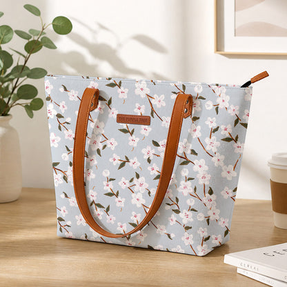 A stylish tote bag with leather handles, featuring a beautiful floral print design. Perfect for any occasion!