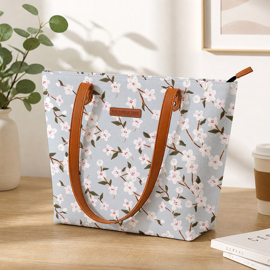A stylish tote bag with leather handles, featuring a beautiful floral print design. Perfect for any occasion!