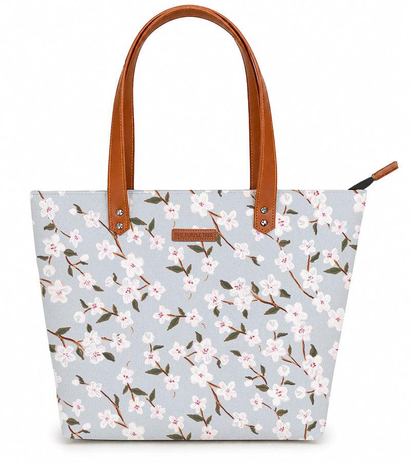 A stylish tote bag with leather handles, featuring a beautiful floral print design. Perfect for any occasion!