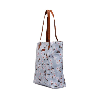 Fashionable tote bag with leather handles and a lovely floral print pattern.
