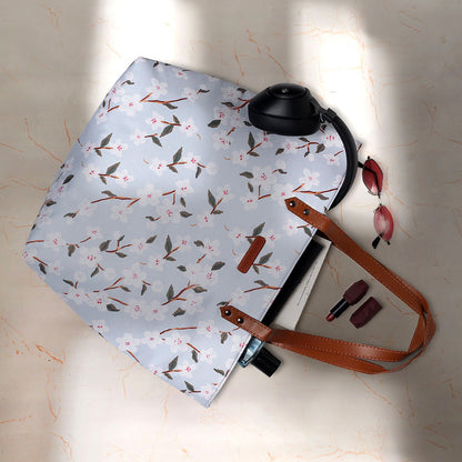 Trendy tote bag with leather handles, showcasing a beautiful floral print.