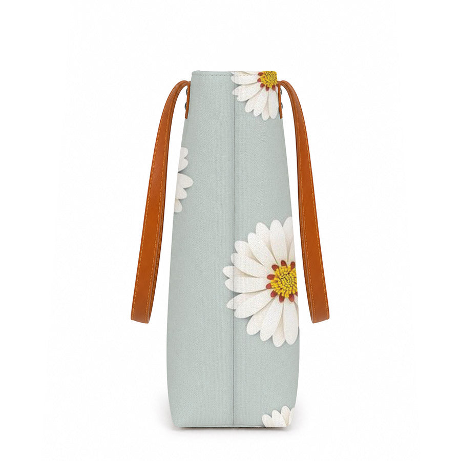 Light blue bag with floral design and brown strap on a white background