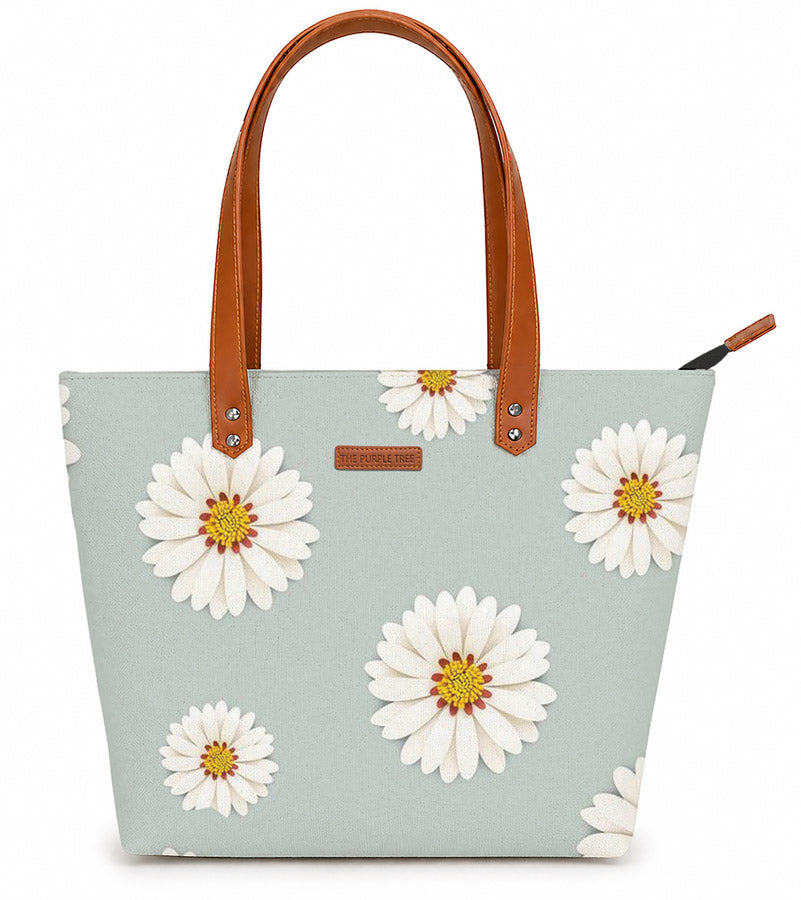 Tote bag with white floral design on a light blue background