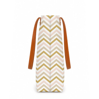 A stylish tote bag with a pink and gold chevron pattern, perfect for adding a touch of elegance to any outfit.