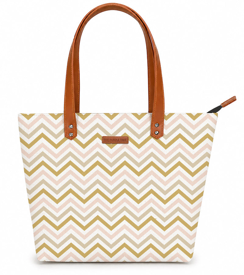 A stylish tote bag with a pink and gold chevron pattern, perfect for adding a touch of elegance to any outfit.
