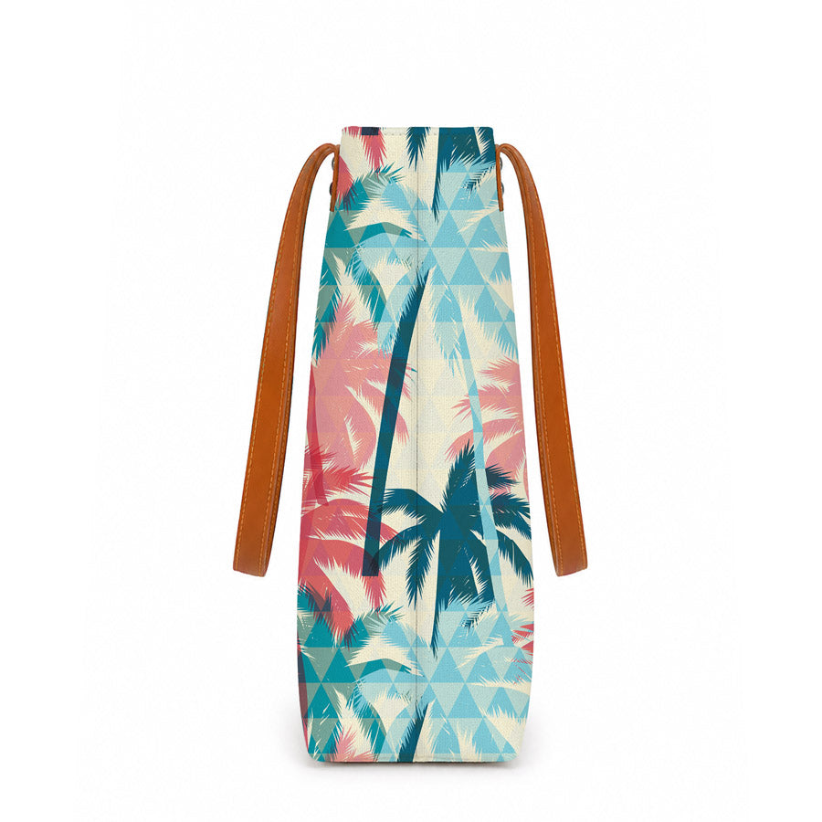 Tote bag with tropical palm tree design and brown straps on a white background
