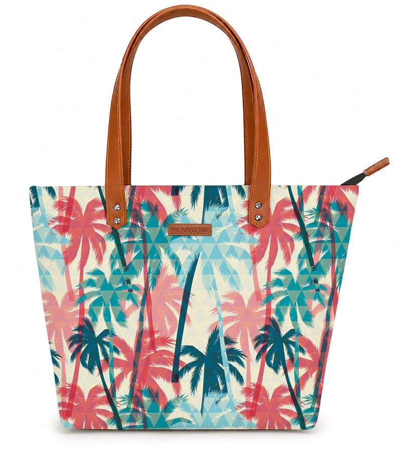 Tote bag with palm tree pattern and brown handles on a white background