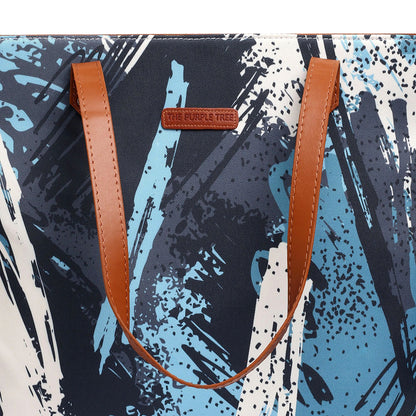  Chic tote bag with a unique paint brush print in blue and white, a practical accessory for creatives.