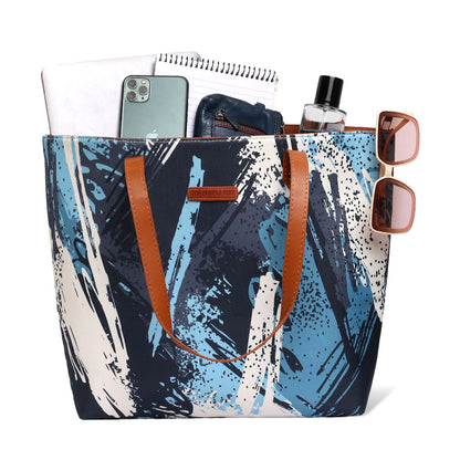 Blue and white tote bag with paint brush print, perfect for carrying art supplies on the go.