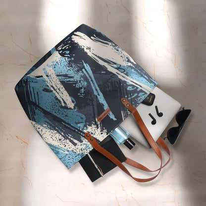 Get creative with this blue and white tote bag adorned with a playful paint brush pattern.