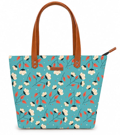 Tote bag with floral pattern and brown handles on a white background