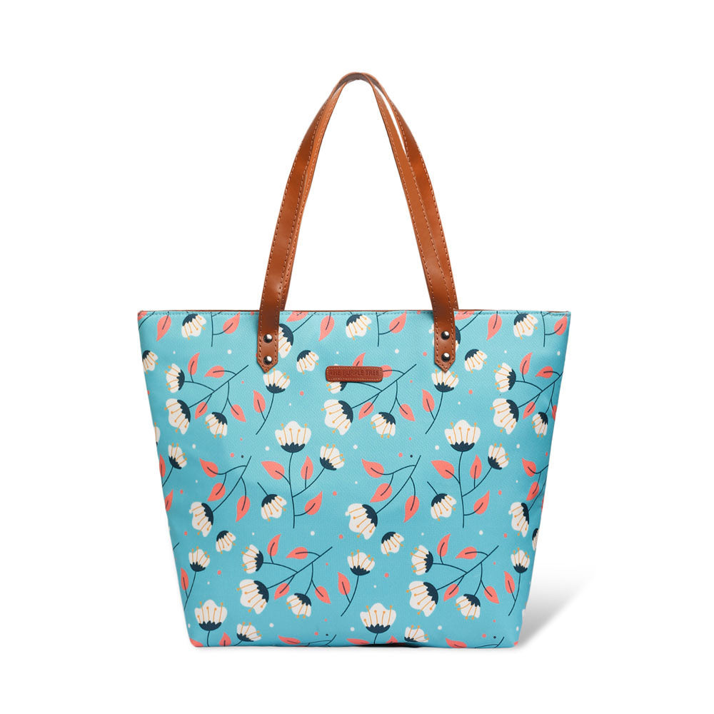 Fashionable tote bag adorned with a lovely blue and white floral print.