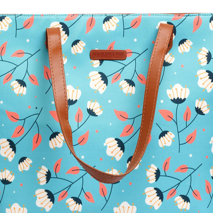 Stylish blue and white tote bag with a lovely floral design, ideal for a day at the beach.