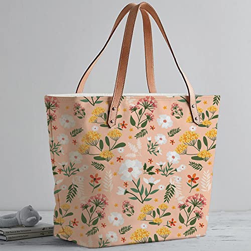 Chic tote bag featuring floral print and brown leather handles.