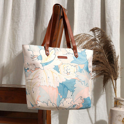 Stylish floral print tote bag, perfect for carrying all your essentials on a sunny day out.