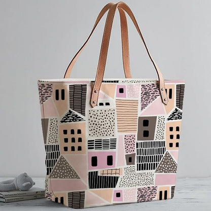  Trendy tote bag with pink and black color scheme and whimsical house pattern.