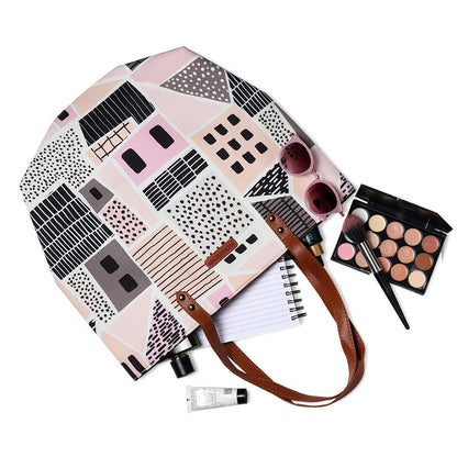 Chic tote bag in pink and black with cute house print, great for adding a pop of color to your outfit.