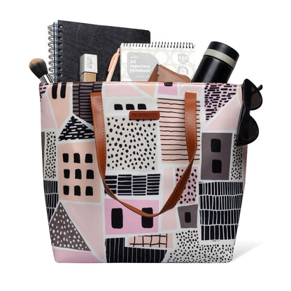 Stylish pink and black tote bag featuring charming house design, ideal for everyday use.