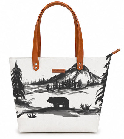 Tote bag with bear and mountain design on a white background