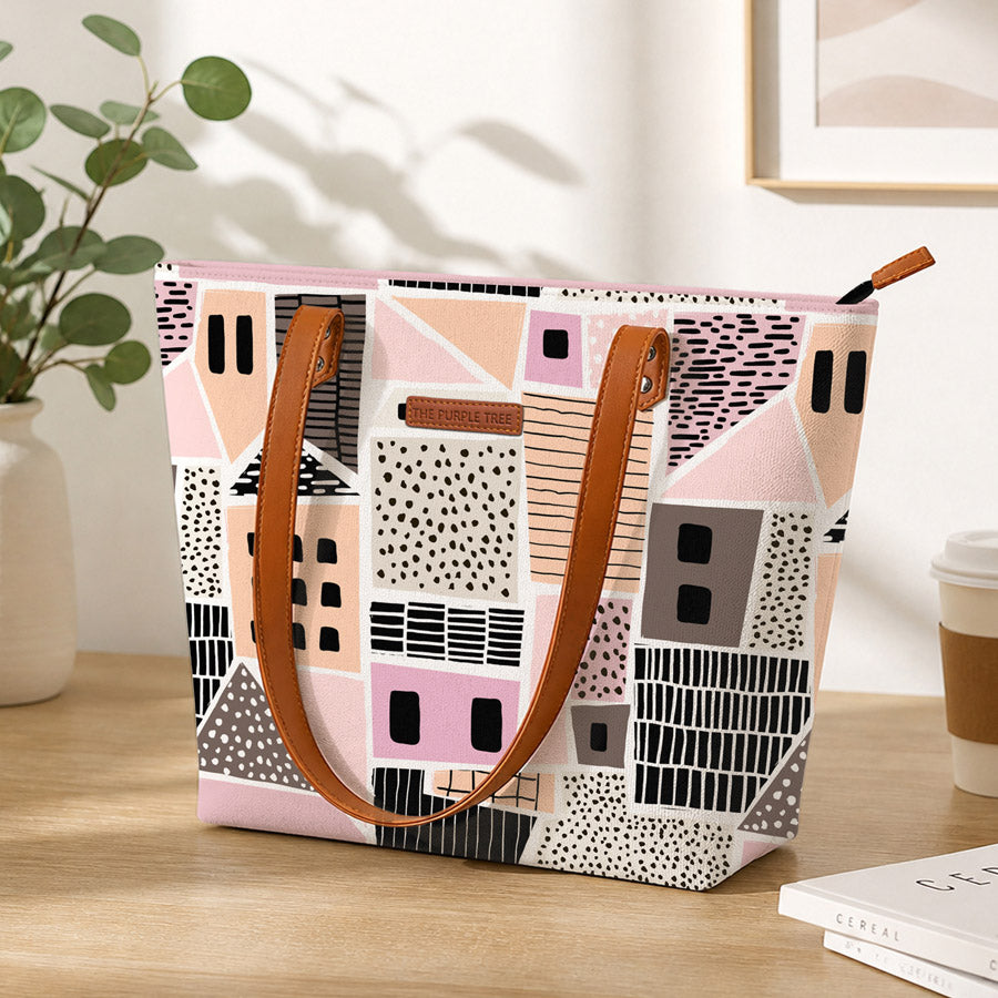 Pink and black tote bag with house pattern, perfect for carrying essentials in style.