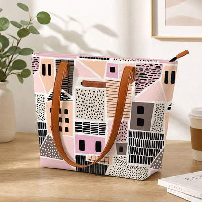 Pink and black tote bag with house pattern, perfect for carrying essentials in style.
