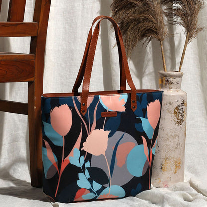 Black and blue floral print tote bag, perfect for carrying essentials in style.