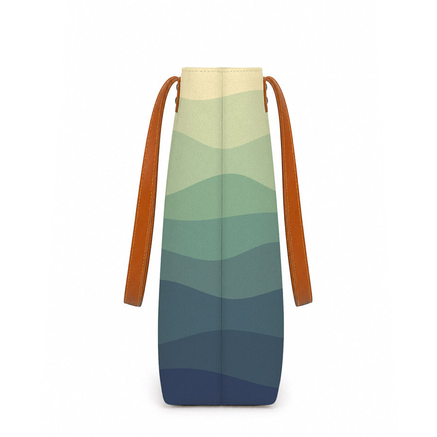 Colorful bag with gradient design and brown straps on a white background