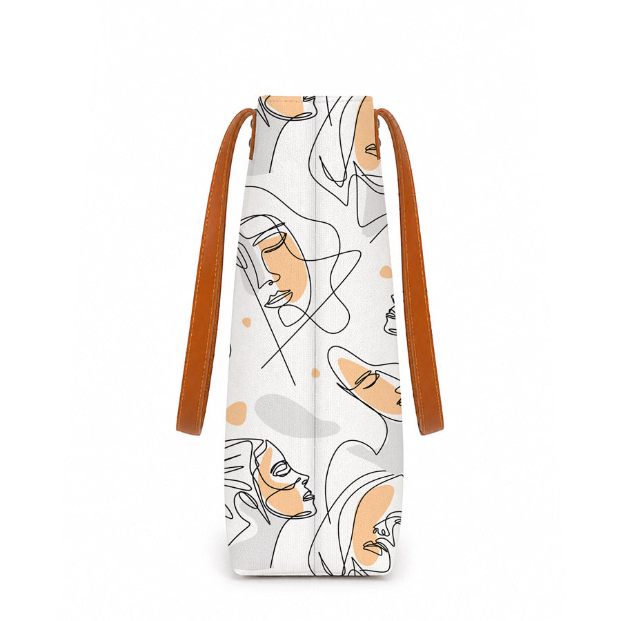 Bag with abstract face design and brown strap on a white background